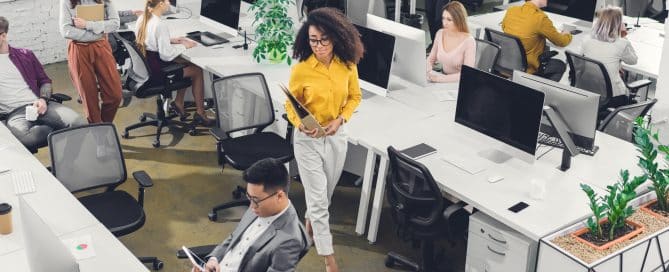 high angle view of professional young business people working with computers and papers in office